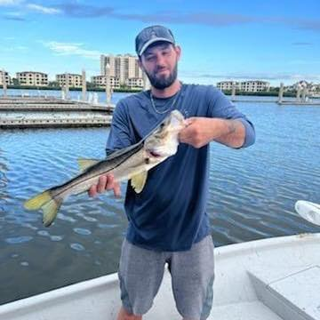 Alex with a fish, representing Bryant's Seamless Guttering on jobs around Shelbyville and nearby areas