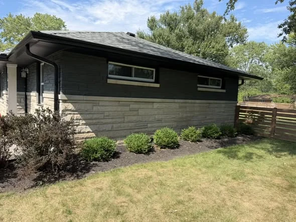 Side view of black seamless gutter installation by Bryant's Seamless Guttering